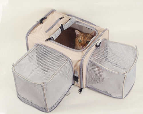 Expandable pet travel bag with side panel opened, giving cat extra room to stretch