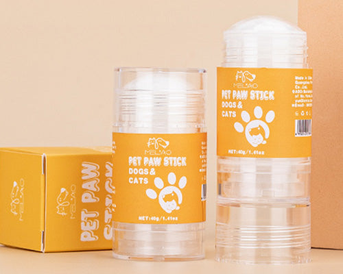 Applying paw balm stick on dog paw easy application