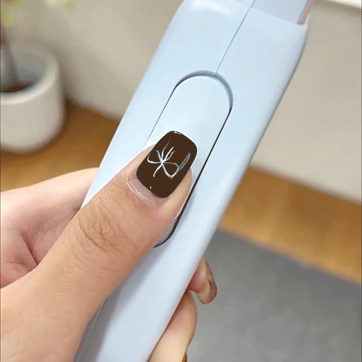 Hand holding a retractable dog leash showing smooth retraction design