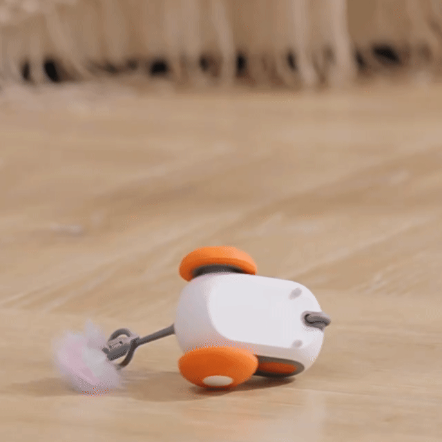 Automatic moving cat toy with self-righting design on wooden floor
