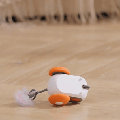 Automatic moving cat toy with self-righting design on wooden floor
